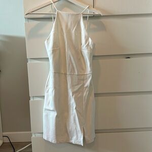 beautiful white dress with a small slit and high open back